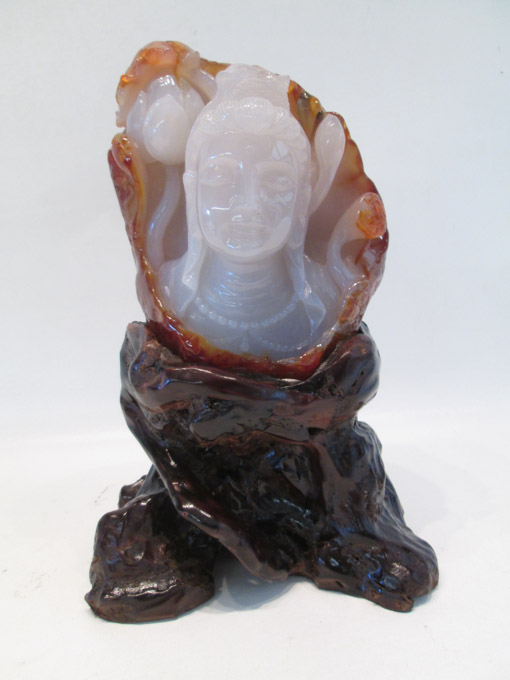 Appraisal: CHINESE CARVED AGATE SCULPTURE depicting Quan Yin with lotus flower