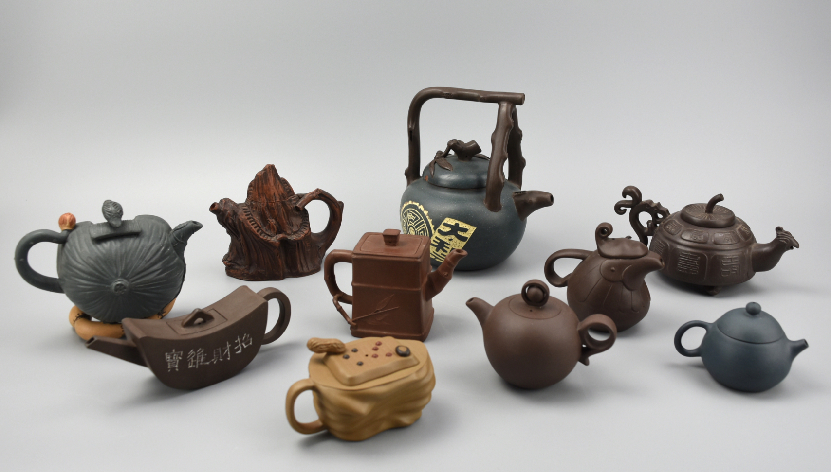 Appraisal: DECORATIVE CHINESE ZISHA TEAPOTS A lot of decorative Chinese earthenware