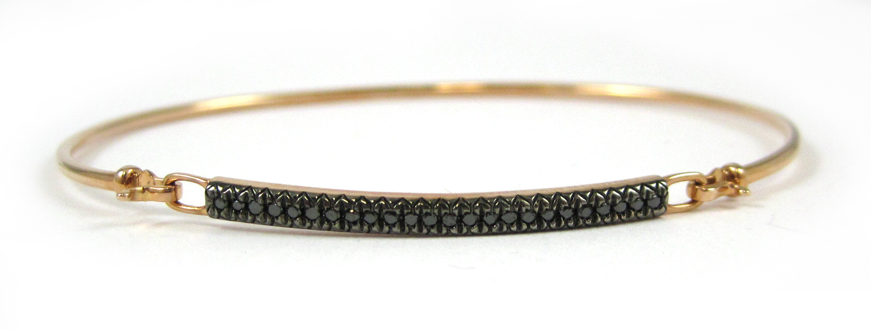 Appraisal: BLACK DIAMOND AND ROSE GOLD BANGLE The oval shaped k