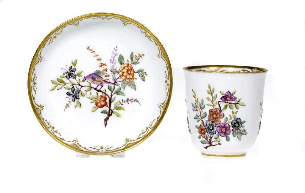 Appraisal: A MEISSEN HAUSMALEREI BEAKER AND SAUCER moulded with prunus painted