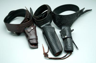 Appraisal: Three tooled leather belts holsters one black with tooled scrolls