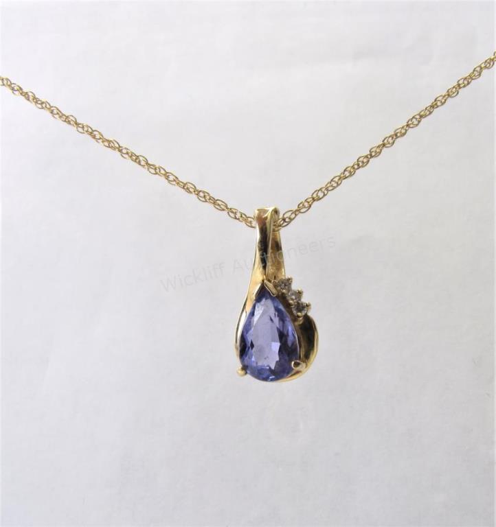 Appraisal: A K yellow gold pear shaped tanzanite pendant with diamond