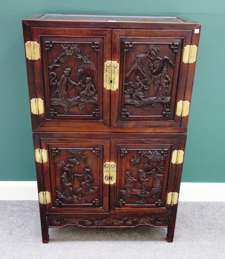 Appraisal: An early th century Chinese hardwood double height side cabinet