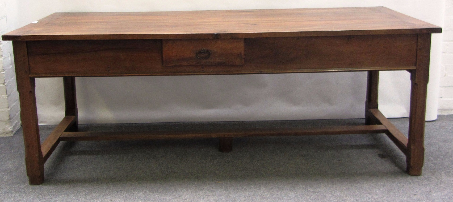 Appraisal: A th century French walnut plank top kitchen table with