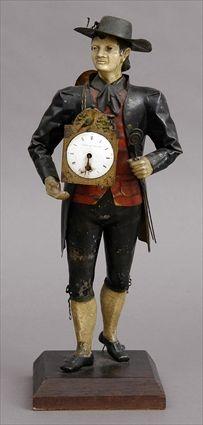 Appraisal: TOLE PEINTE FIGURAL CLOCK The enamel face signed F Ardley