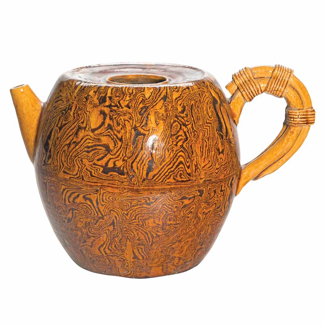 Appraisal: Chinese Amber Glazed Marbled Teapot Tang Dynasty The barrel shaped