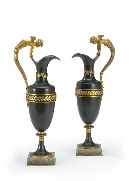 Appraisal: A pair of Empire style patinated and gilt bronze ewers