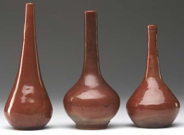 Appraisal: MARBLEHEAD Three bottle-shaped vases covered in frothy oxblood glaze From