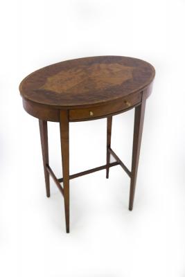 Appraisal: An oval satinwood and yew wood side table fitted a