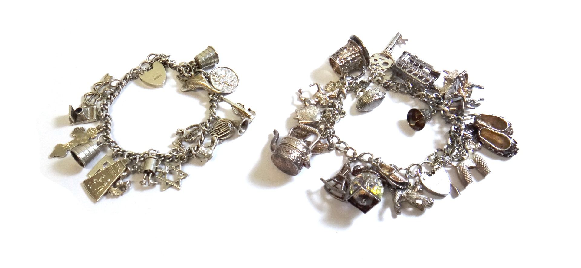 Appraisal: Two silver curb link charm bracelets with silver heart shaped