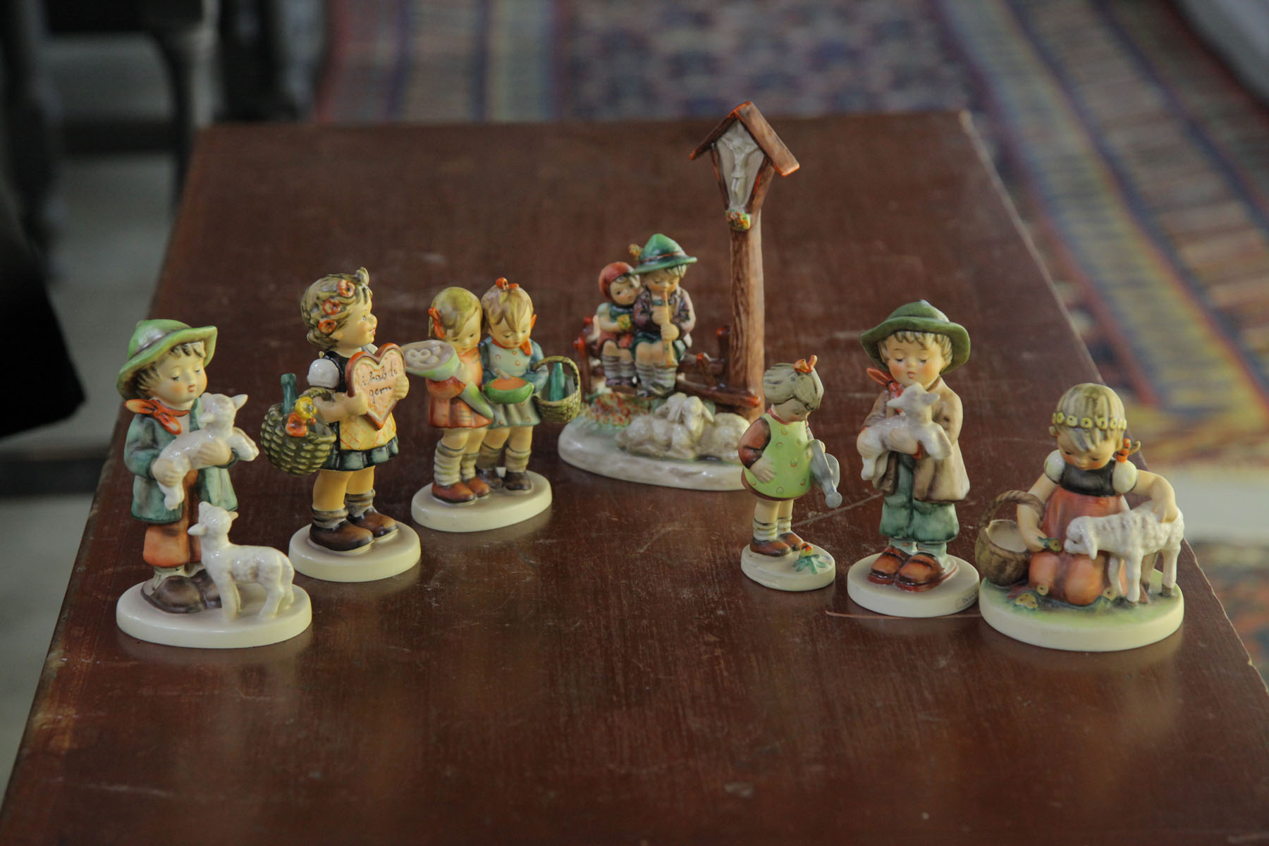 Appraisal: SEVEN HUMMEL FIGURINES German th century ''Going to Grandma's'' with