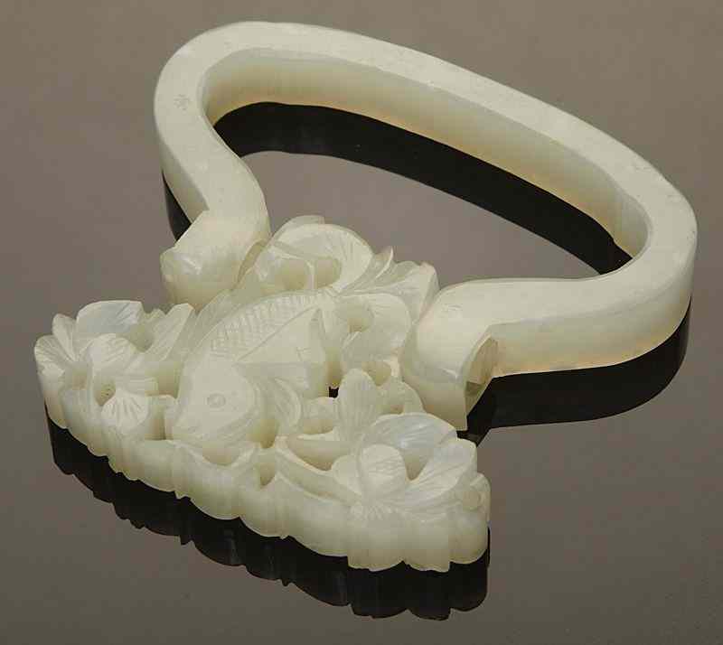 Appraisal: Chinese Qing white jade belt hook carvedto depicting fish and