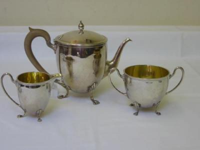 Appraisal: A THREE PIECE TEA SERVICE of everted beehive form the