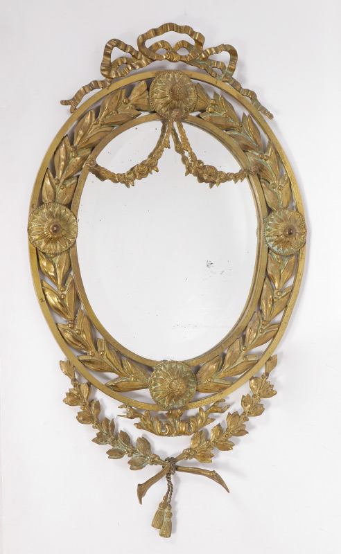 Appraisal: CONTINENTAL BRASS FOLIATE MOTIF WALL MIRROR Oval mirror with ribbon