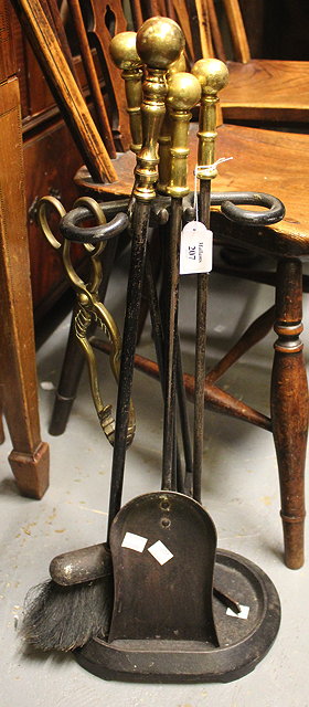 Appraisal: A BRASS AND IRON SET OF FIRE IRONS on stand