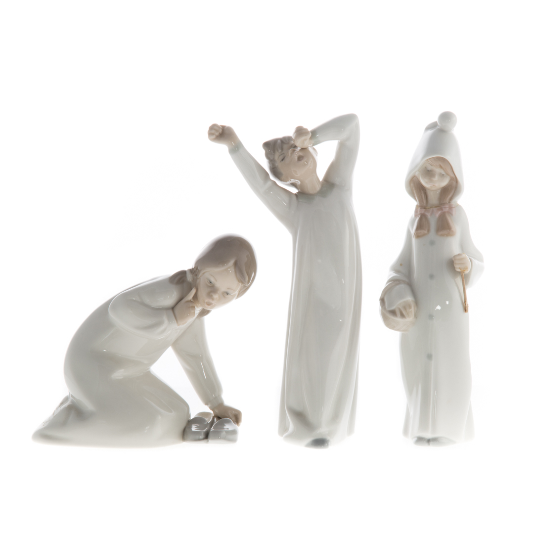 Appraisal: Three Lladro porcelain figures including girl with slippers in H