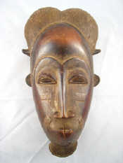 Appraisal: A hardwood mask with scarification marks and dressed hair possibly