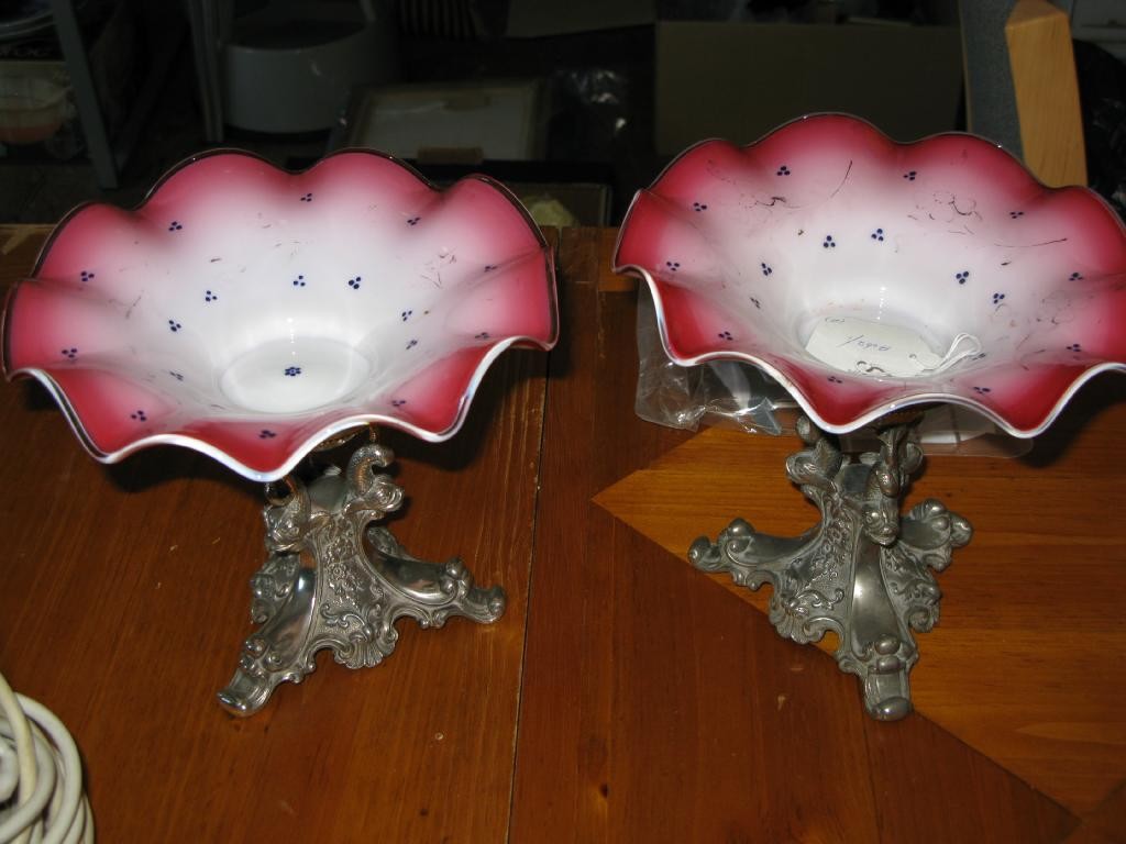 Appraisal: A pair of coloured glass comports on pewter stands cast