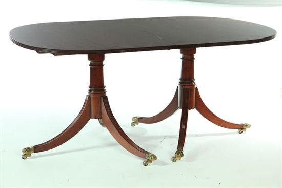 Appraisal: NEOCLASSICAL-STYLE DINING TABLE Twentieth century mahogany Two pedestals with splayed