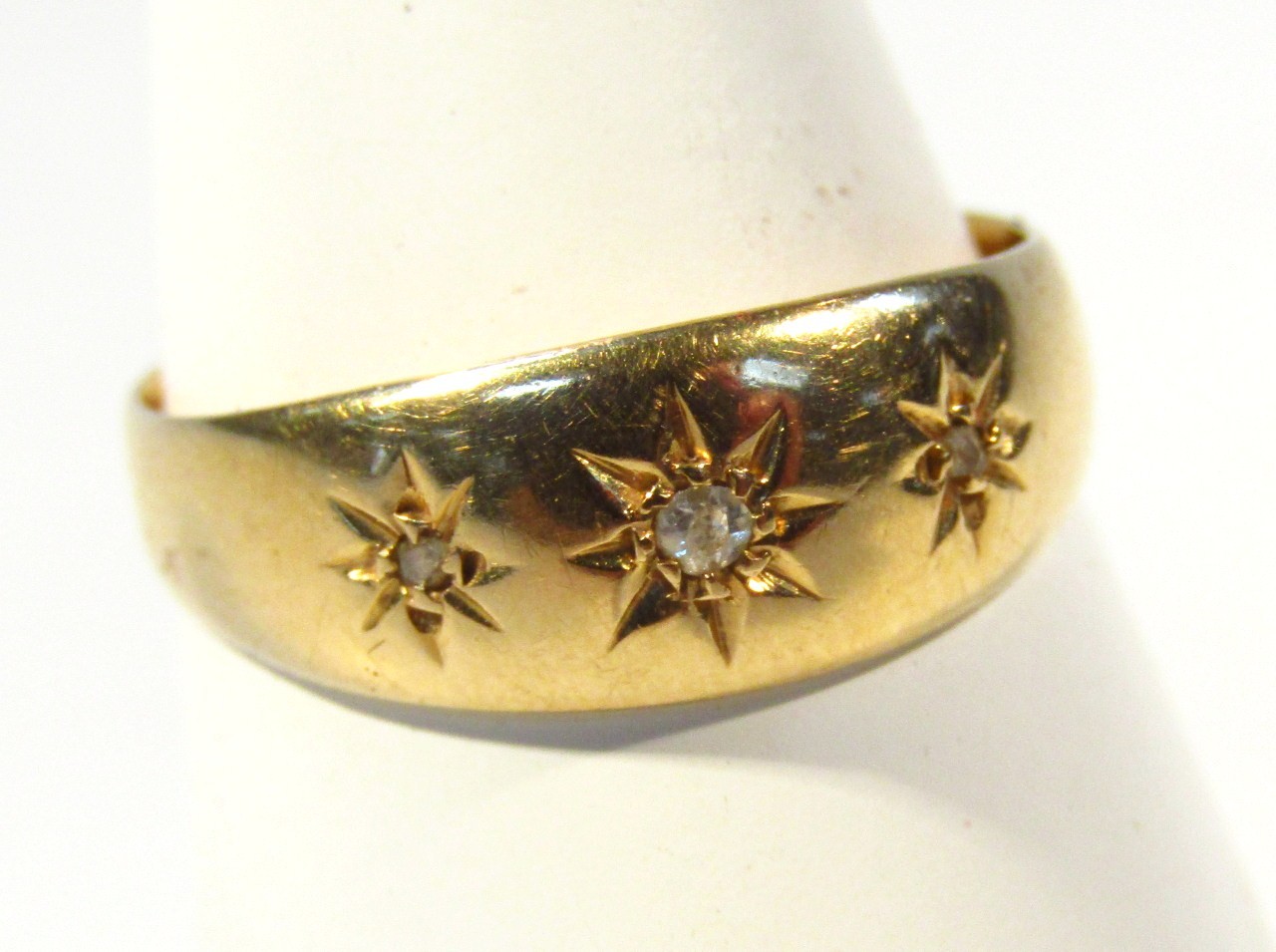 Appraisal: A ct gold ring set with three small diamonds size