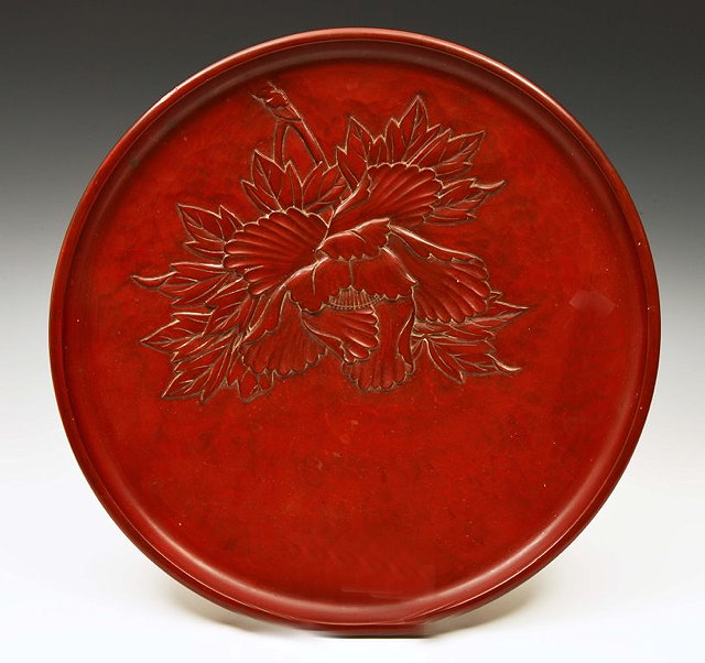 Appraisal: A JAPANESE RED CINNABAR CIRCULAR TRAY with leaf carved decoration