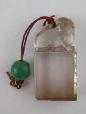 Appraisal: A carved Chinese rock crystal seal with jade bead approx