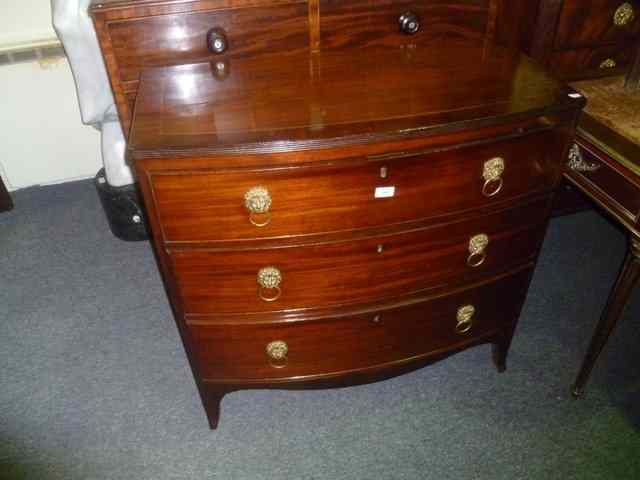 Appraisal: A GEORGIAN MAHOGANY BOW FRONT CHEST of three long drawers