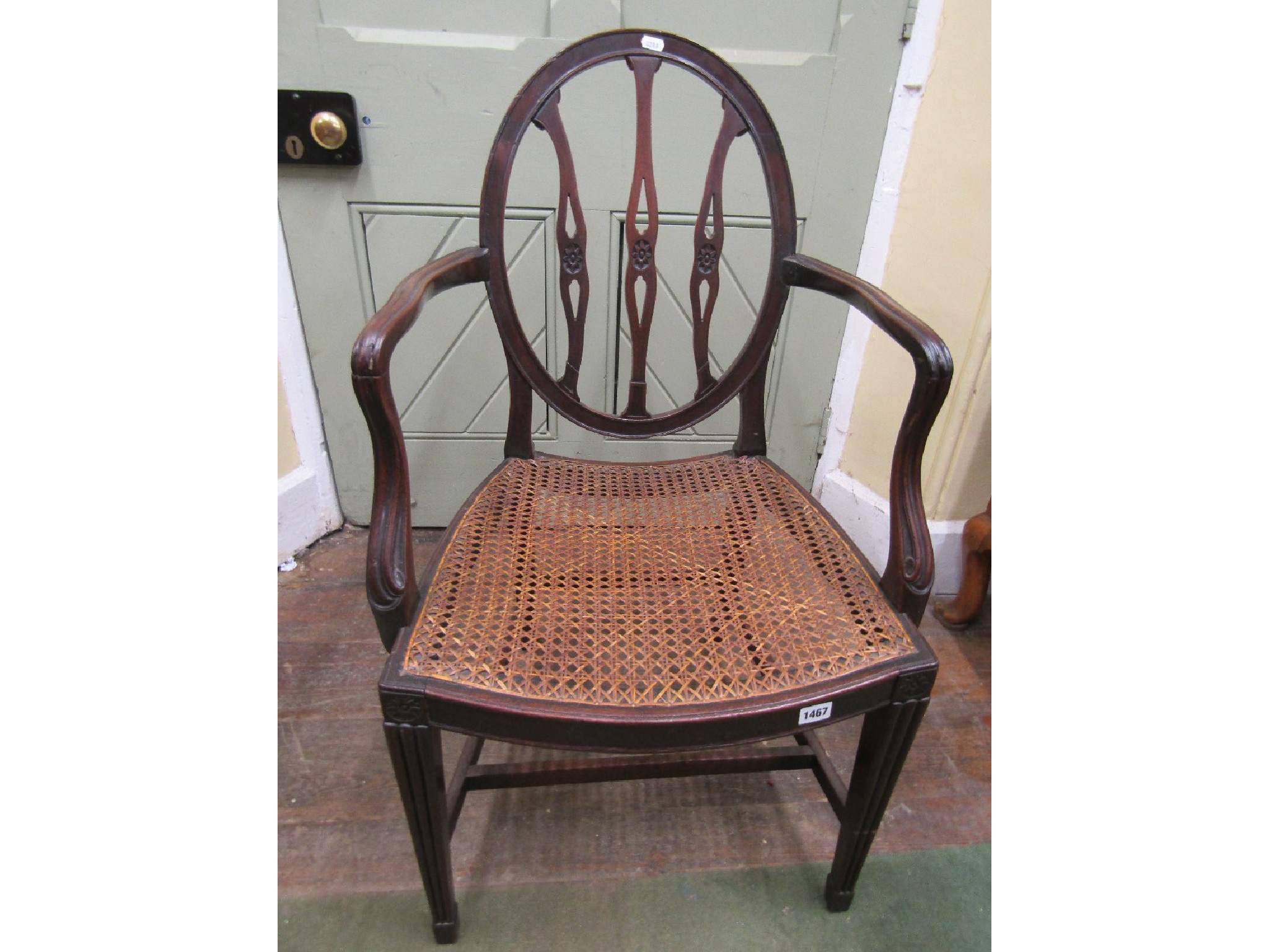 Appraisal: An th century Hepplewhite elbow chair with oval back supporting