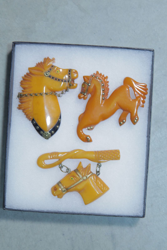 Appraisal: THREE BAKELITE HORSE PINS All butterscotch or cream corn ''h