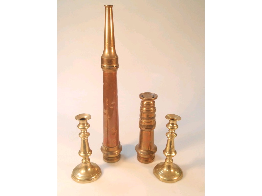 Appraisal: Two brass and copper fireman's hose nozzles and a pair