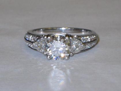 Appraisal: A DIAMOND RING with central stone approximate weight cts flanked