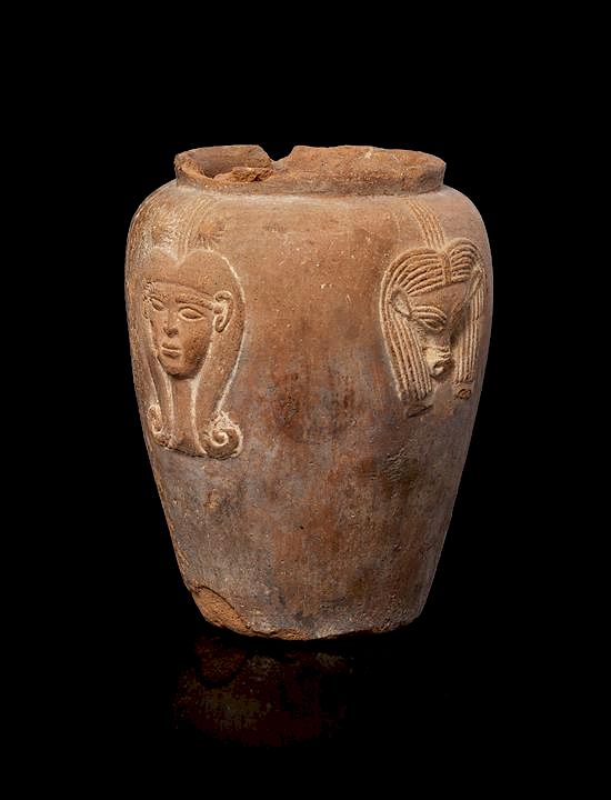 Appraisal: An Egyptian Terra Cotta Jar with Hathor Height inches An