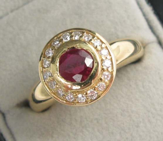 Appraisal: RUBY DIAMOND AND FOURTEEN KARAT GOLD RING centering a round-cut