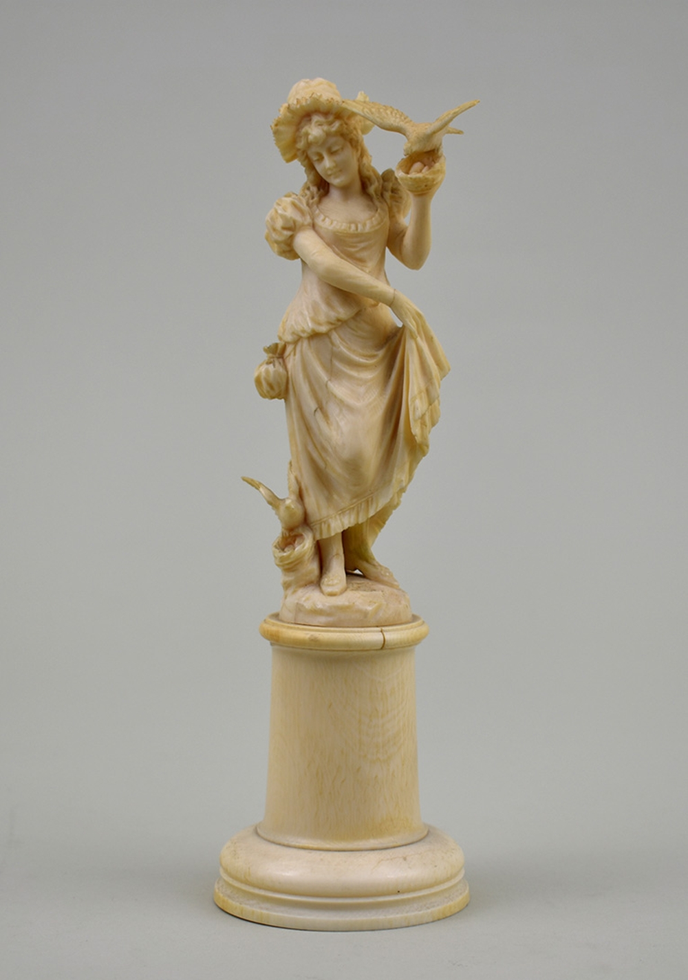 Appraisal: CONTINENTAL IVORY FIGURE OF A MAIDEN IN FANCIFUL ATTIRE th