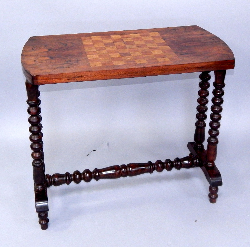 Appraisal: A Victorian walnut centre table with chequerboard top bobbin turned