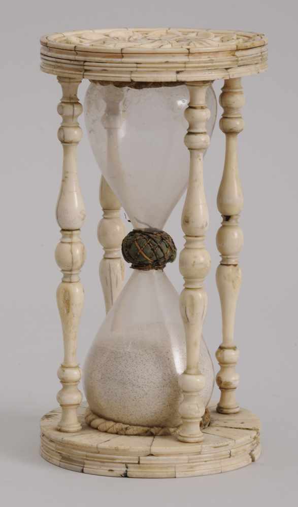 Appraisal: CONTINENTAL CARVED IVORY HOUR GLASS The end discs with pinwheel