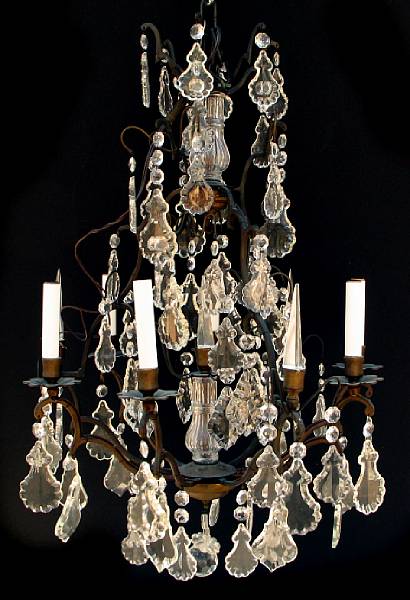 Appraisal: A patinated metal and cut glass chandelier hung with facet