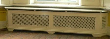 Appraisal: A double pierced cast radiator surround with pierced returns and