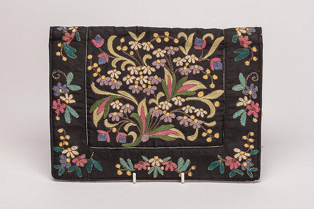 Appraisal: A s black evening bag embroidered with a colourful floral