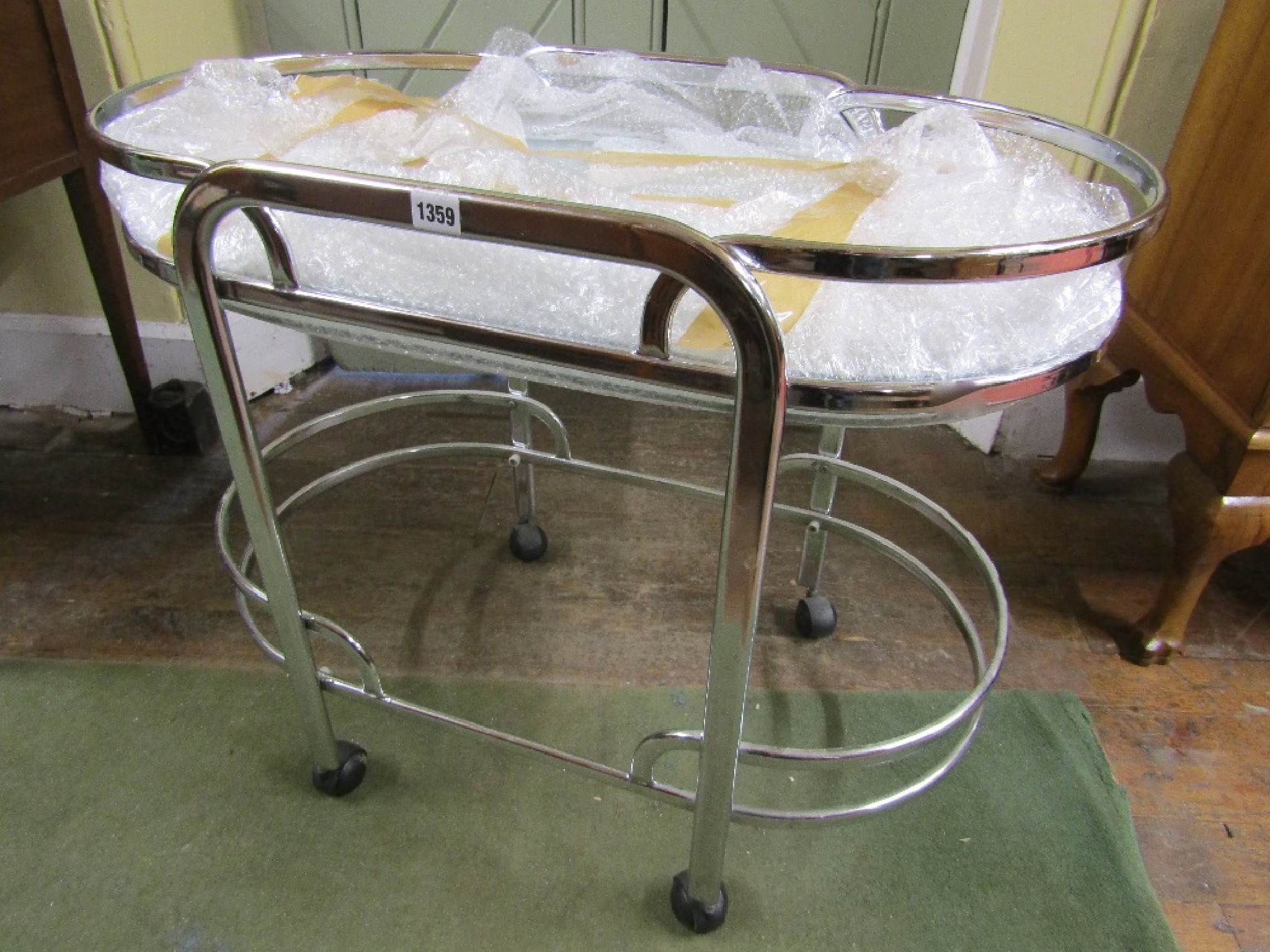 Appraisal: An Art Deco style two tier tea trolley in chrome