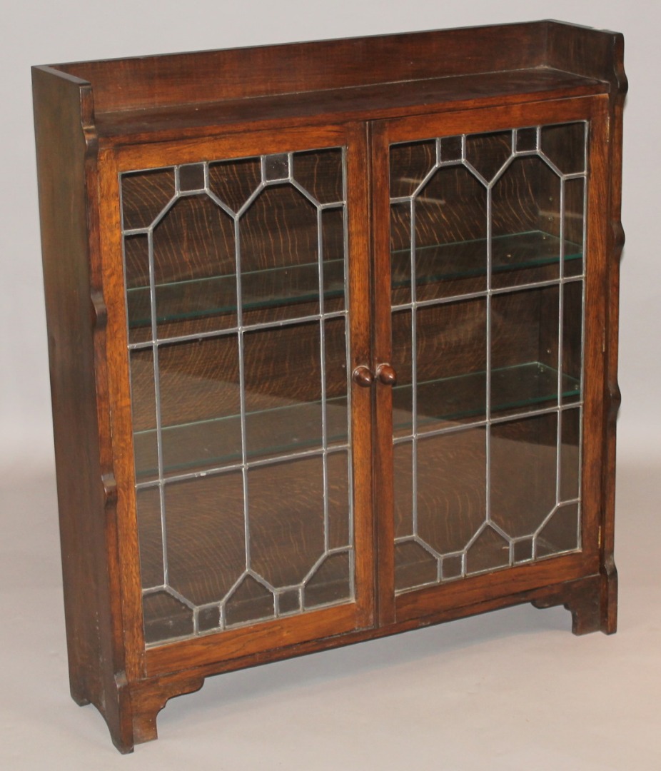 Appraisal: A thC Ercol style oak finish display cabinet with a