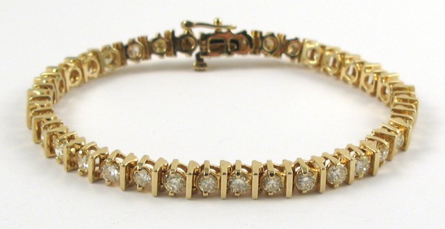 Appraisal: DIAMOND AND FOURTEEN KARAT GOLD BRACELET in length and set