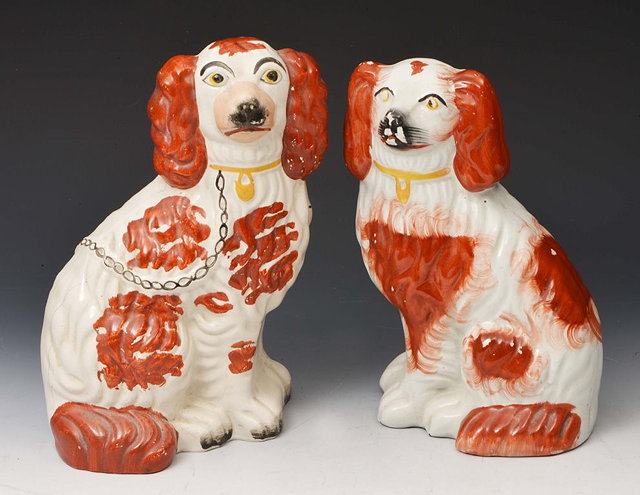 Appraisal: A PAIR OF VICTORIAN POTTERY STAFFORDSHIRE DOGS