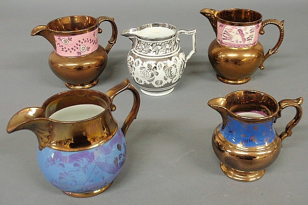 Appraisal: Four copper luster pitchers largest h and a silver luster