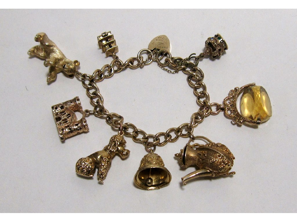 Appraisal: Nine carat gold charm bracelet with substantial sized charms to