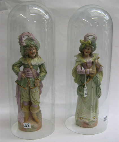 Appraisal: PAIR OF PAINTED BISQUE FIGURES AND GLASS DOMES hand painted