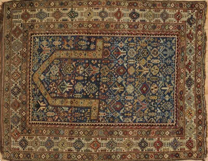 Appraisal: CAUCASIAN BLUE-GROUND PRAYER RUG The abrashed field worked with floating