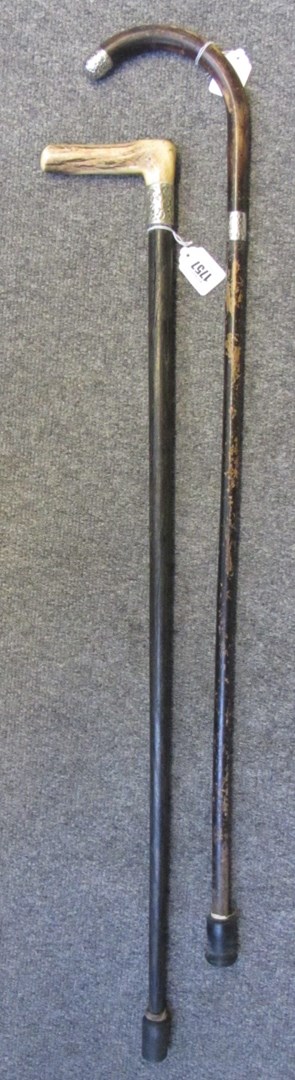 Appraisal: A Victorian walking stick with horn handle and silver collar