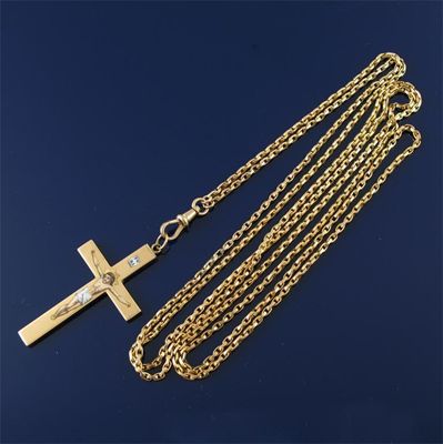 Appraisal: A gold crucifix pendant the figure of Christ enamelled suspended