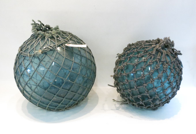 Appraisal: TWO JAPANESE GLASS FISHING FLOATS with original nets Diameters to